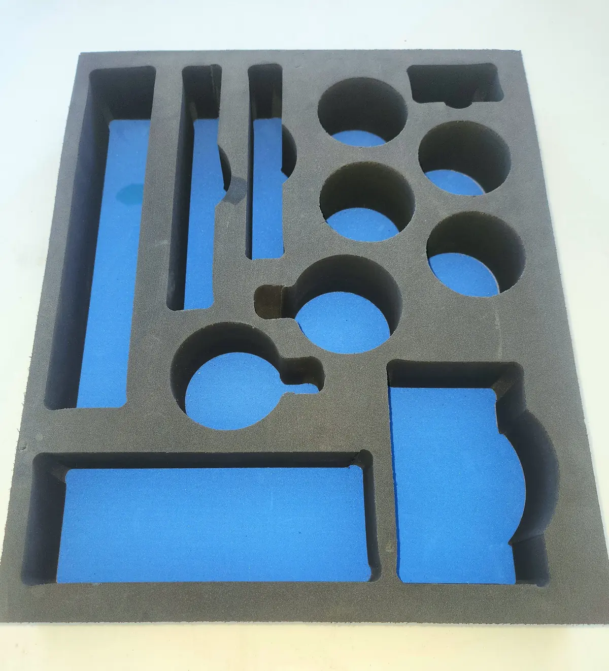 Custom-cut foam packaging inserts protecting products